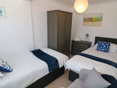 A bedroom with two beds and a wardrobe at Goetra