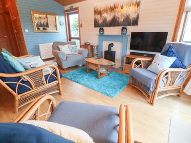 A living room with a sofa and coffee table at Lamorna in Sennen