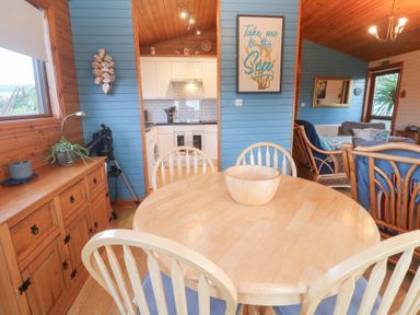 A dining room featuring a table and chairs at Lamorna in Sennen