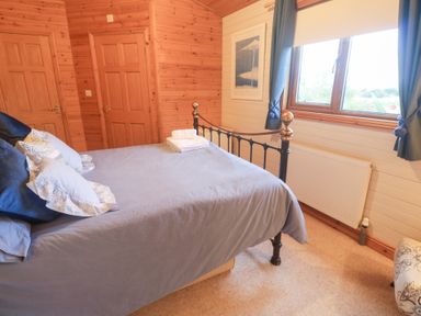 A bedroom with a bed and window at Lamorna Sennen