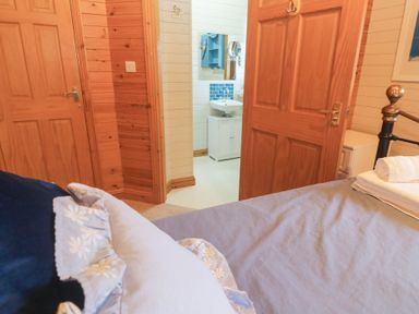 A bedroom with a view of the bathroom at Lamorna Sennen