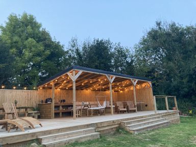 An outdoor structure with chairs and a hammock at Treovis Cottage in Callington
