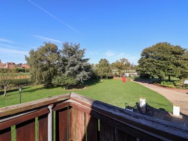A garden with trees and a red phone box at East Cottage in East Knapton near Rillington