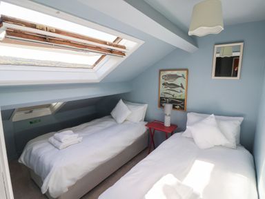 A bedroom with two twin beds and a skylight at West Cottage in East Knapton near Rillington