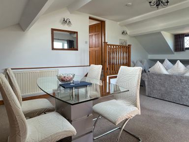 A living room with a dining table and chairs at East Cottage East Knapton near Rillington