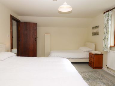 A bedroom with two beds at The Milking Shippon at Thorne near Great Torrington