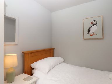 A bedroom with bed and a lamp at The Milking Shippon at Thorne Langtree near Great Torrington