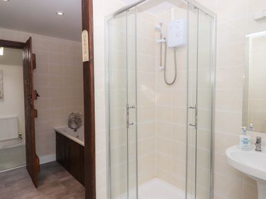 A bathroom with a shower, sink, and bathtub at The Milking Shippon at Thorne Langtree near Great Torrington