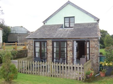 A house with a porch and garden at The Milking Shippon at Thorne Langtree near Great Torrington