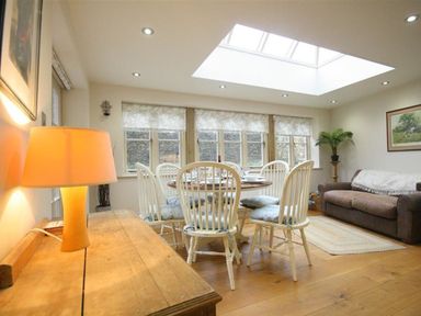 A dining room with a table and chairs at The Coach House in Burford