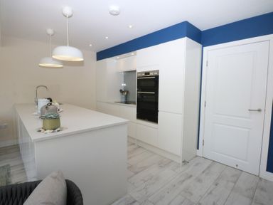 A kitchen with a counter and oven at 2 Lon Y Dryw in Trearddur Bay