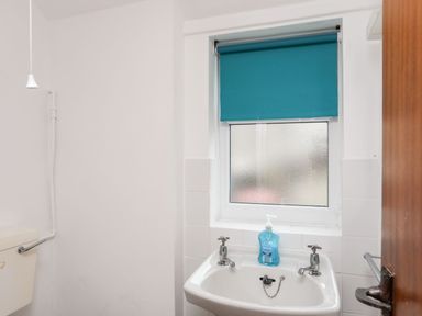 A bathroom with a toilet and sink at Ceiriad - 9 Ty'n Don Llanengan near Abersoch