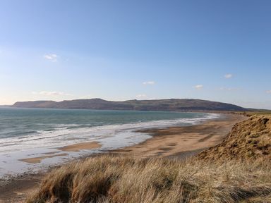 A beach view with sand and sea at Ceiriad - 9 Ty'n Don Llanengan near Abersoch