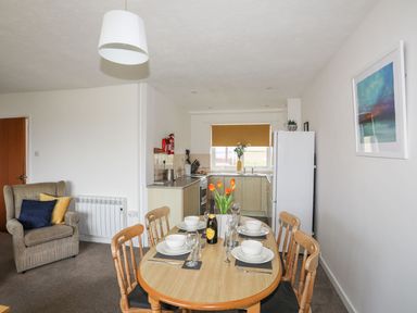 A dining area with a table and chairs at Oer - 8 Ty'n Don, Llanengan near Abersoch