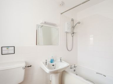 A bathroom with a sink, toilet, shower, and bathtub at Oer - 8 Ty'n Don Llanengan near Abersoch