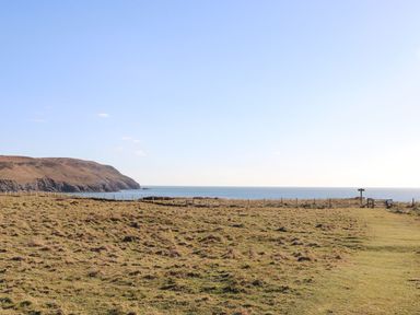 A coastal landscape with grasslands and ocean at Oer - 8 Ty'n Don Llanengan near Abersoch