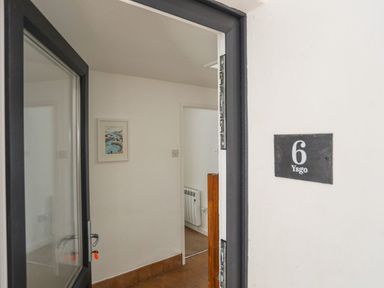 An entrance with door and number plate at Ysgo - 6 Ty'n Don in Abersoch