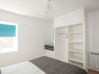 A bedroom with a bed and closet at Ysgo - 6 Ty'n Don Abersoch