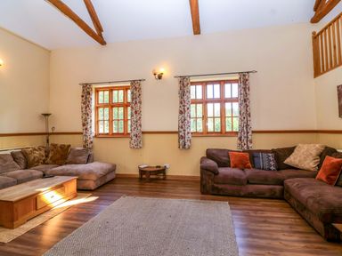 A living room with sofas and a coffee table at Millbarn in Crowcombe