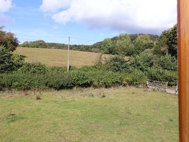 A view of a field and trees at Millbarn in Crowcombe