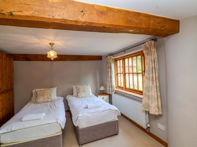 A bedroom with two single beds at Millbarn in Crowcombe