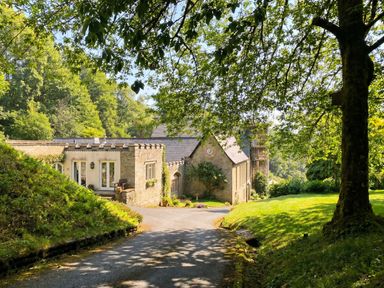 A house with a driveway and trees at 2 Sheplegh Court Blackawton near Dartmouth