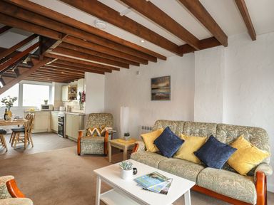 A living room with a sofa and a coffee table at Fadrun - 3 Ty'n Don