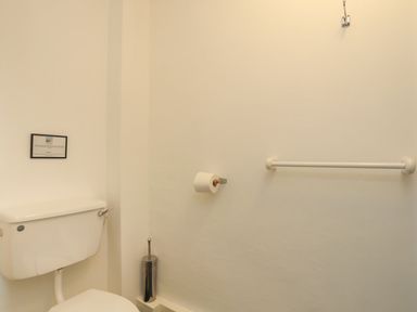 A bathroom with a toilet and toilet paper holder at Fadrun - 3 Ty'n Don