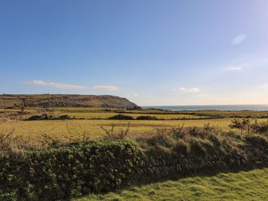 A landscape view featuring land and ocean at Towyn - 7 Ty'n Don