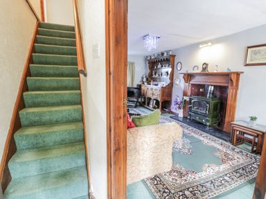 A living room with a sofa and fireplace at The Old Post Office in null