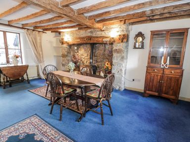 A dining room with a table and chairs at The Old Post Office in null
