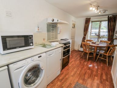 A kitchen with appliances and dining area at The Old Post Office null