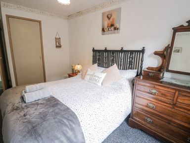 A bedroom with a bed and chest of drawers at The Old Post Office null