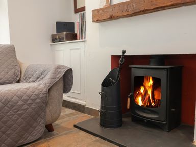 A living room with a sofa and a fireplace at Lenny's Place Watchet