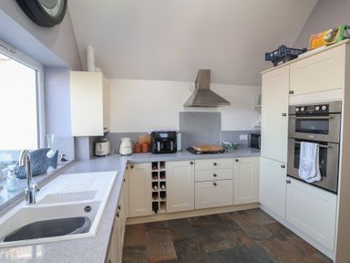A kitchen with countertops and appliances at Lenny's Place in Watchet