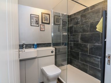 A bathroom with a shower and sink at Lenny's Place in Watchet