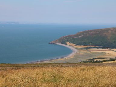 A coastal view with a beach and fields at Lenny's Place in Watchet