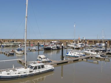 A marina with various boats docked at Lenny's Place Watchet