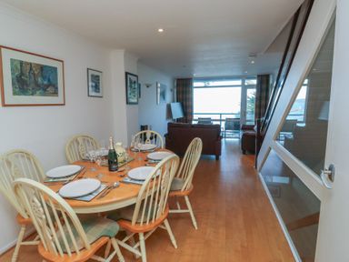 A dining area with a table and chairs at 20 Heath Court in Brixham
