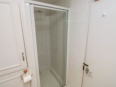 A shower enclosed in glass with a door in a bathroom at 20 Heath Court in Brixham