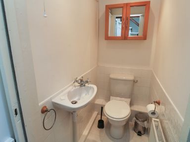 A bathroom with toilet and washbasin at 20 Heath Court in Brixham