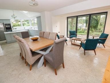 A dining room with a table and chairs at Hawthorns