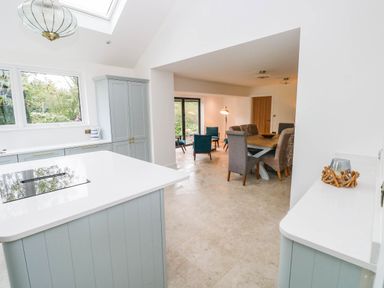 A kitchen with a countertop and dining area at Hawthorns