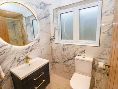 A bathroom with a sink, toilet, and a shower enclosure at Hawthorns