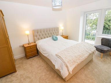 A bedroom with a bed and wardrobe at Hawthorns 