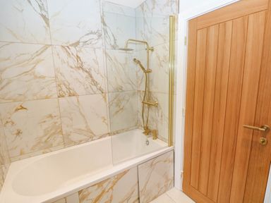A bathroom with a bathtub and shower at Hawthorns