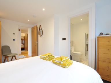 A bedroom with a bed and towels on it at The Dairy in 