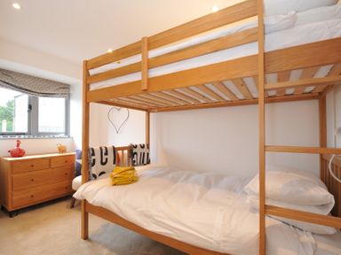 A bedroom with a bunk bed and a dresser at The Dairy
