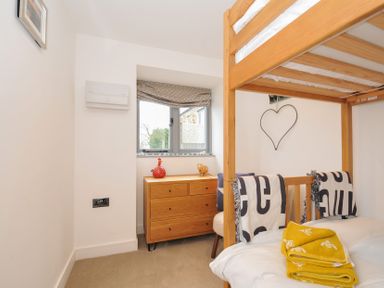 A bedroom with a bunk bed and a drawer unit at The Dairy in 