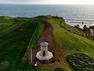 An aerial view of a gazebo on a cliff overlooking the ocean at The Dairy in Bridgerule